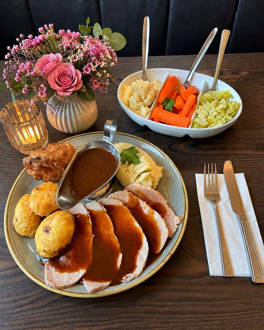Sunday roast at Oily's — sliced roast pork with gravy, roast potatoes, mash and a Yorkshire pudding, with a dish of vegetables to share